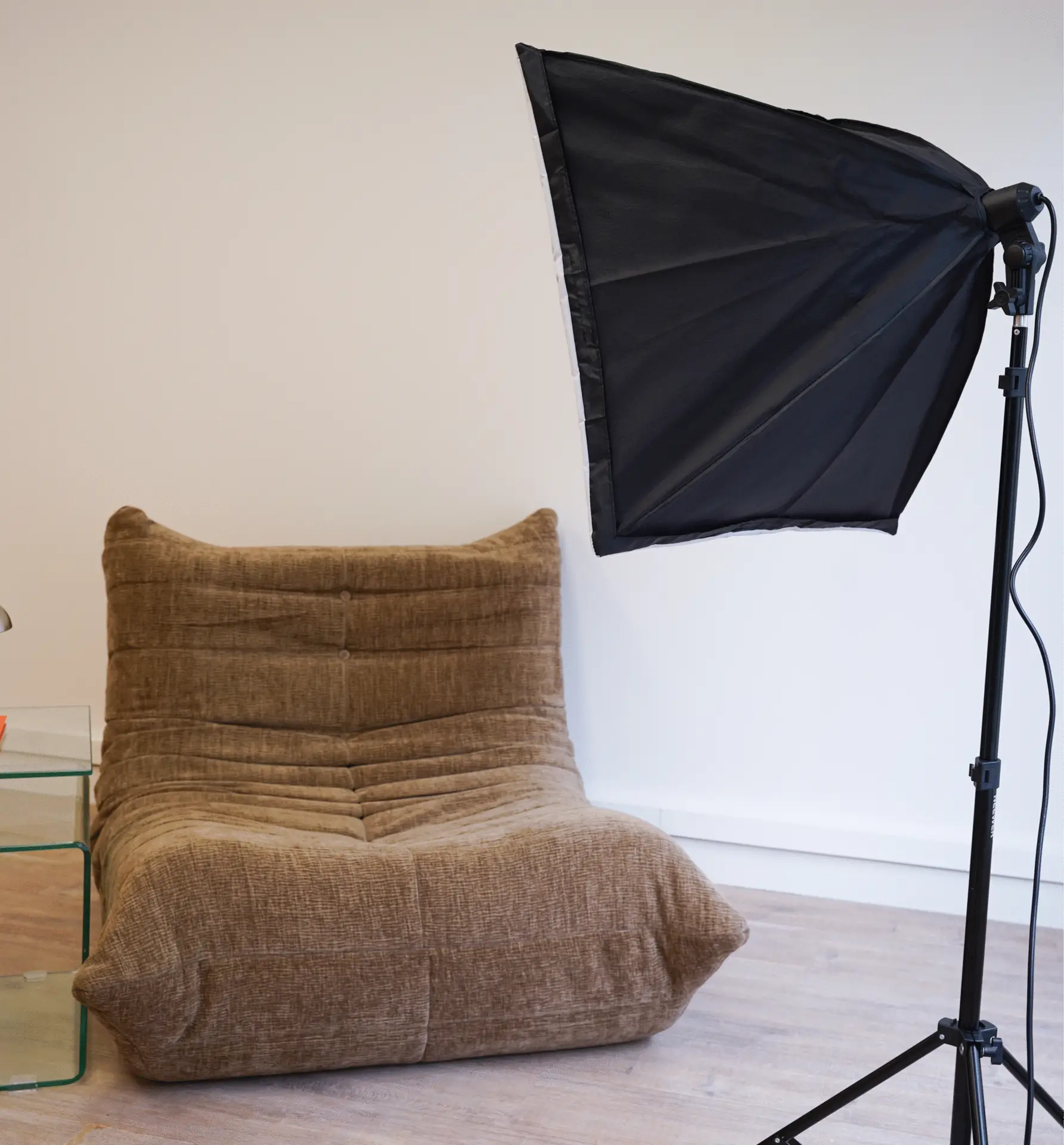 Studio setup with brown lounge chair and professional softbox lighting in Antwerp
